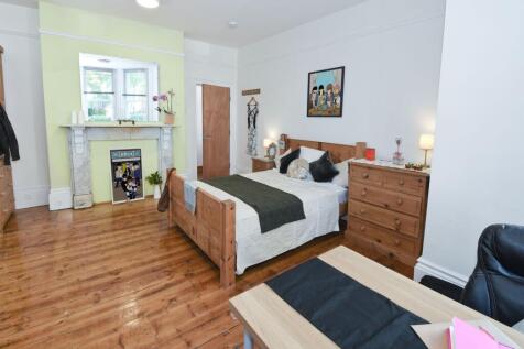 Bright, stylish bedroom with warm wooden floors...