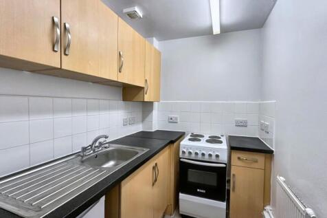 Clean kitchen with ample storage space...