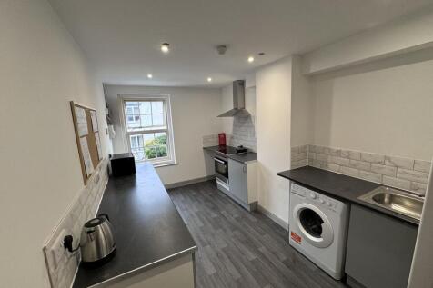 Bright kitchen with modern appliances and stora...