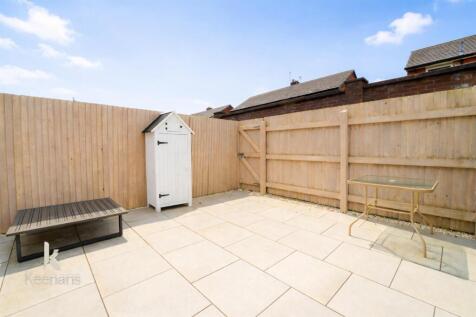 Sunny patio with beach hut shed.jpg