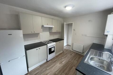 Bright, modern kitchen with fitted cabinets, fu...