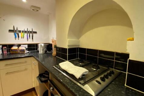 Modern kitchen with sleek dark countertops....