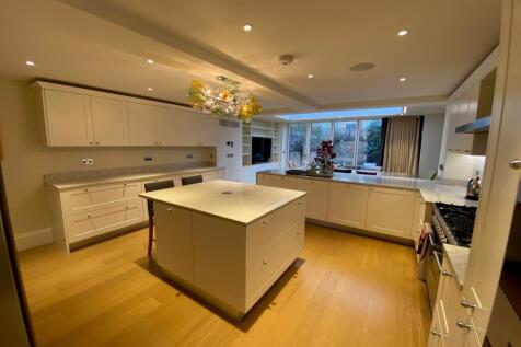 Spacious contemporary kitchen with a central is...