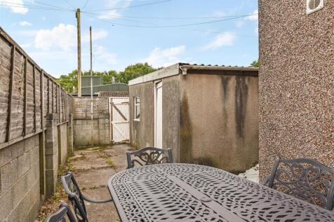 Private paved garden with outdoor seating...