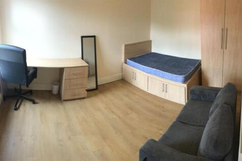 Spacious room with desk, sofa, and double bed...
