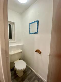 Clean, bright cloakroom with modern wood floori...