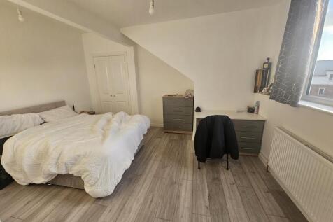 Bright and spacious master bedroom featuring a ...