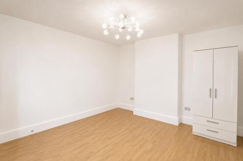 Bright bedroom with stylish lighting and wardro...