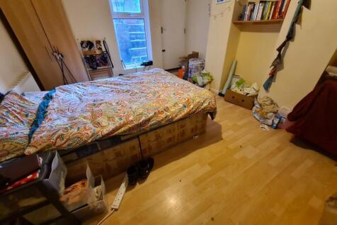 A cozy bedroom featuring a double bed with bedd...