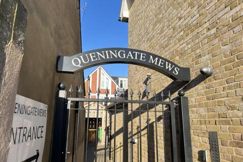 Secure gated entrance under a clear blue sky...