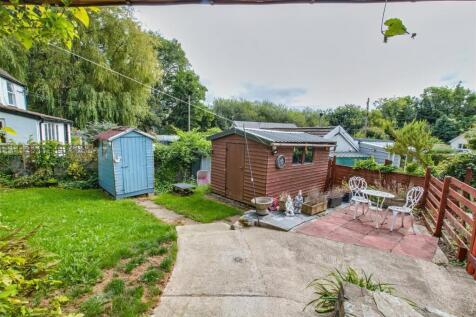 Side of property and garden sheds