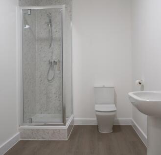 A modern bathroom featuring a sleek shower encl...