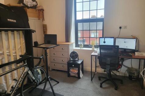 Bright, well-organised bedroom with a large sas...