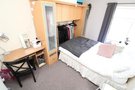 Bright bedroom with desk and ample storage spac...