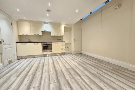 Open-plan living area and fitted kitchen