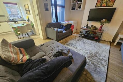 Bright, modern living room with comfortable sof...