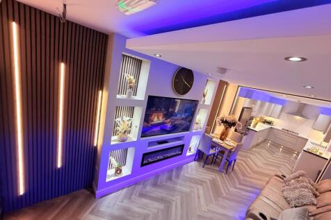 Stylish open-plan living area with built-in med...