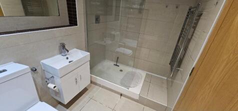 Contemporary tiled bathroom with a walk-in show...