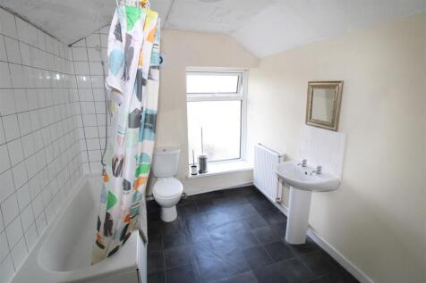 Bright bathroom with full tub and natural light...
