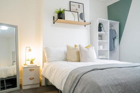 A beautifully styled double bedroom featuring a...