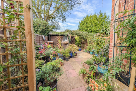 Lush Trellised Backyard Garden Path.png