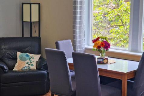 Bright, inviting living/dining area with a comf...