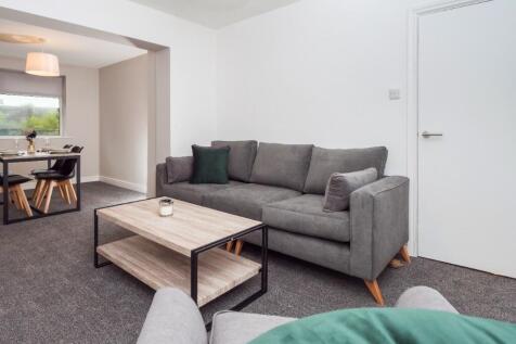 Bright, modern living room with a comfortable g...