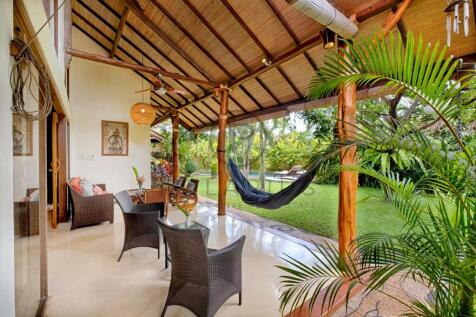 Spacious covered patio with outdoor furniture and 