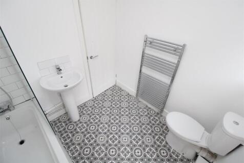 Modern bathroom with stylish patterned flooring...