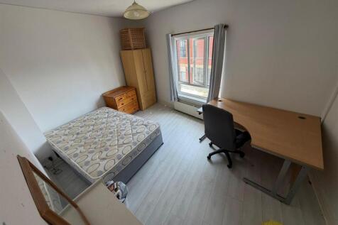 Bright bedroom with study desk and double bed...