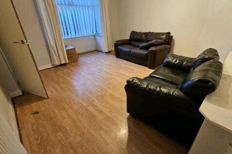 Bright living space with cozy leather sofas...