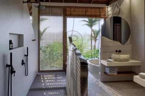 A modern, open-air bathroom with a tropical view, 