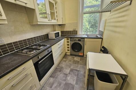 A well-lit, modern kitchen featuring spacious c...