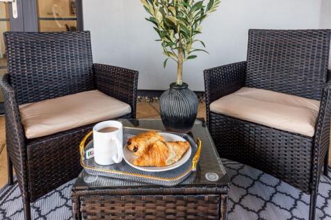 Cozy outdoor seating area featuring two cushion...