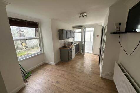 Bright open-plan living area with bay window...