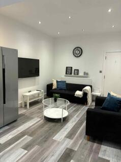 A modern and well-lit living room featuring sle...