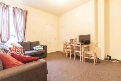 Bright communal living room with comfortable so...