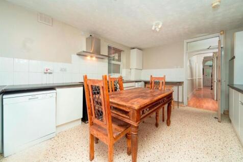 Bright kitchen with dining table and fitted uni...
