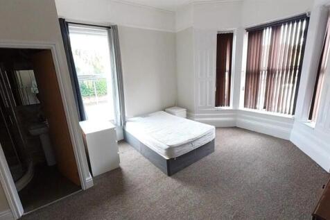 Spacious bedroom with bright bay windows...