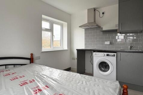 Bright, simply furnished bedroom with a double ...