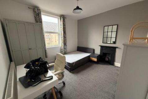 Bright, neutrally decorated double bedroom with...