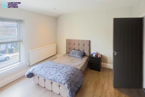 Bright modern bedroom with stylish wood floorin...