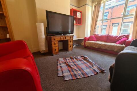 A bright, welcoming living room featuring large...