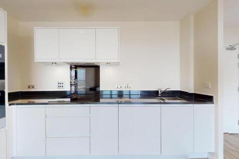 Sleek contemporary kitchen with integrated oven...