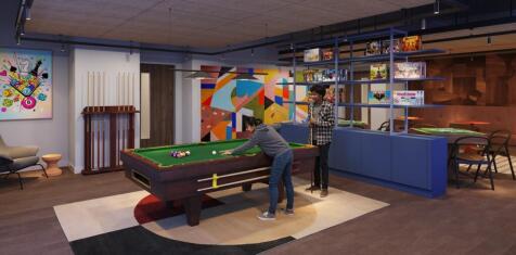 Modern communal lounge with a pool table, color...