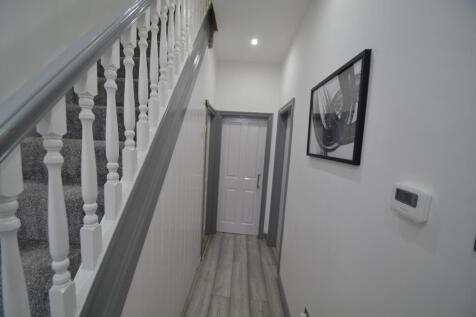 Bright, freshly painted hallway with modern flo...