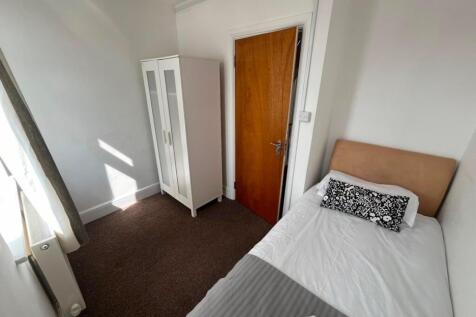 Bright bedroom with a modern wardrobe and bed...