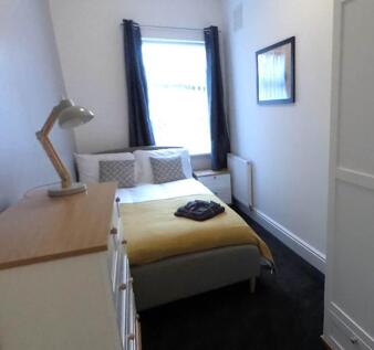 Bright bedroom with double bed and stylish lamp...