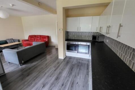 Open-plan living area with a modern kitchenette...