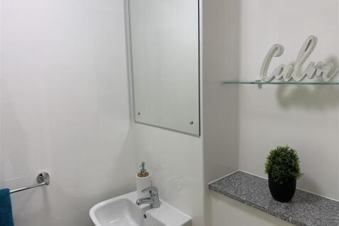 Pristine modern bathroom with stylish shelving...